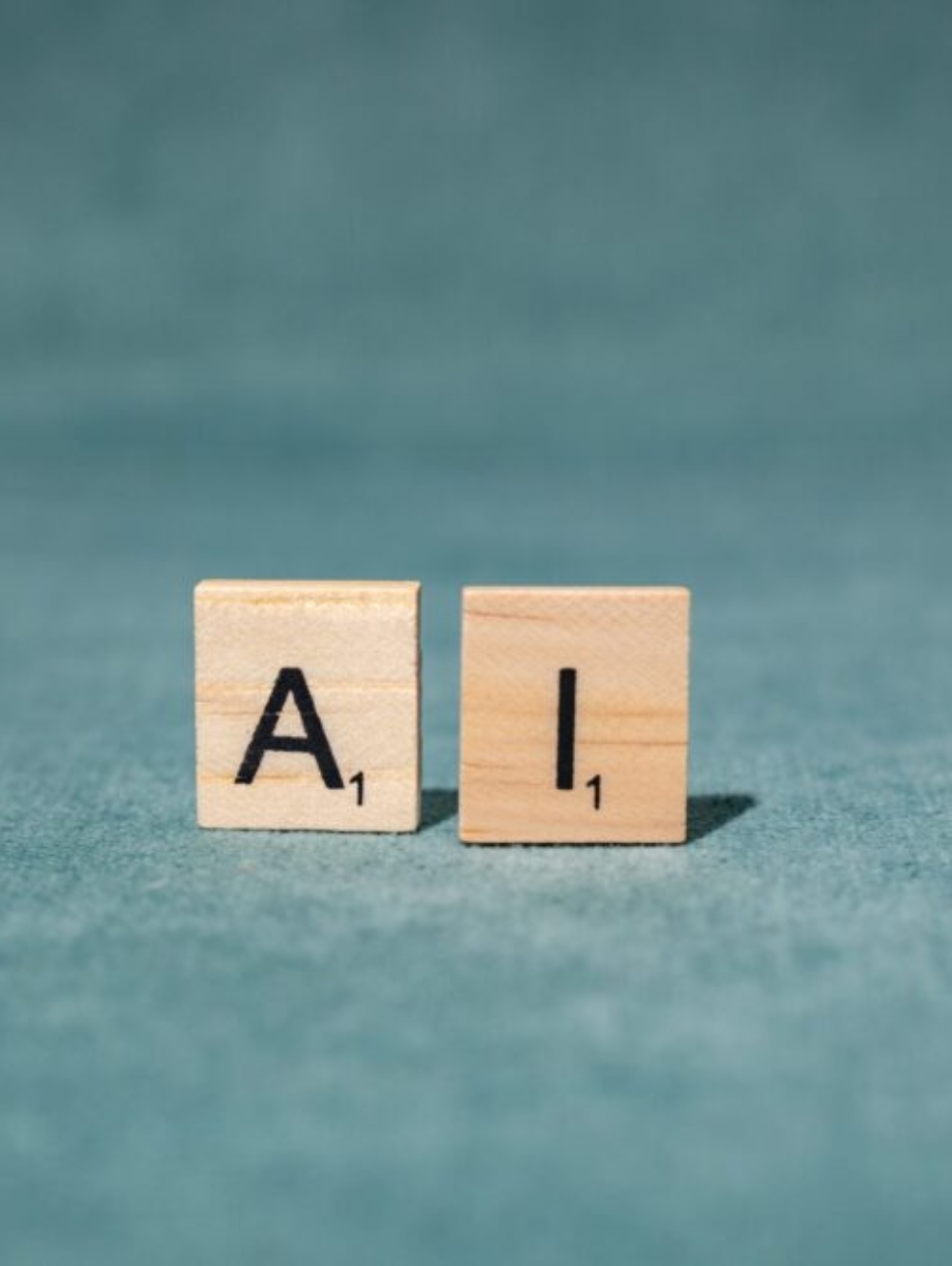 Wooden letter tiles spelling AI on a textured green background, symbolizing artificial intelligence.