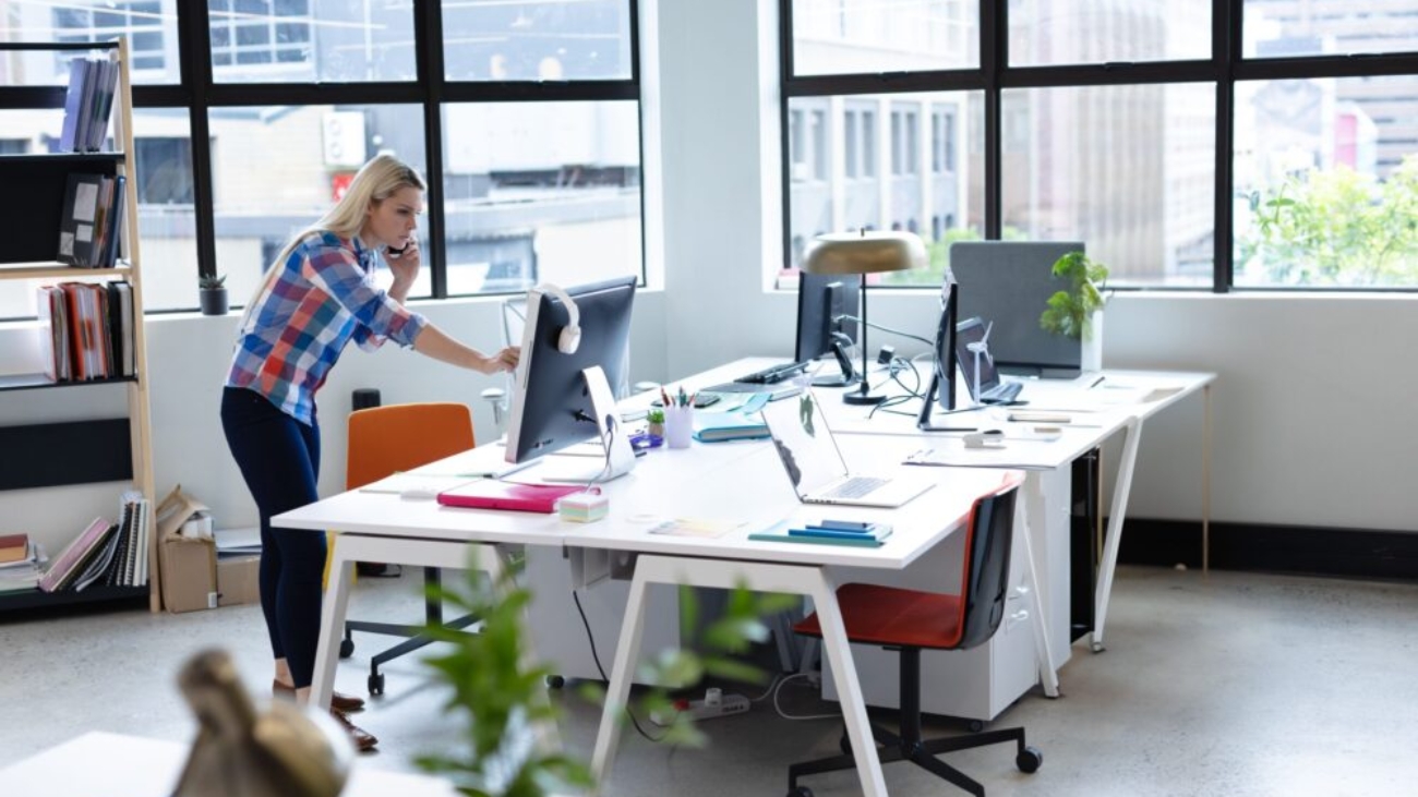 Woman working on finances in an open-plan Irish charity office