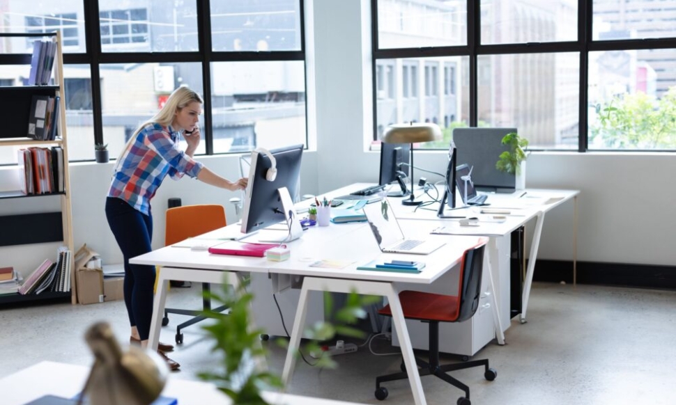 Woman working on finances in an open-plan Irish charity office