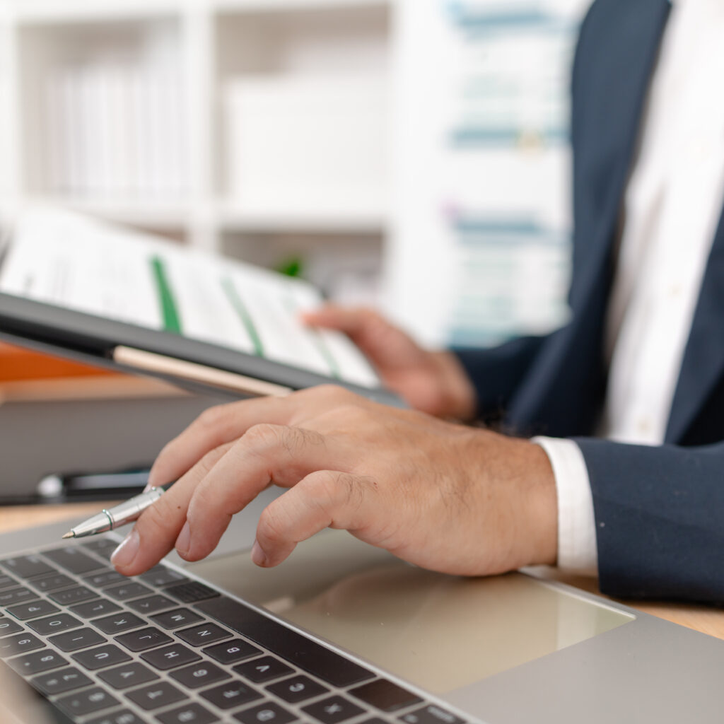A businessman in a suit analysing financial charts using Sage accounting software