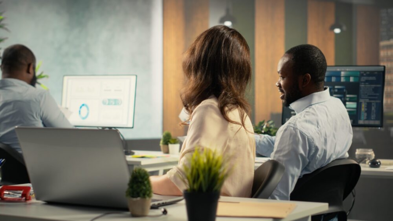 Employees reviewing business intelligence dashboards and analytics data