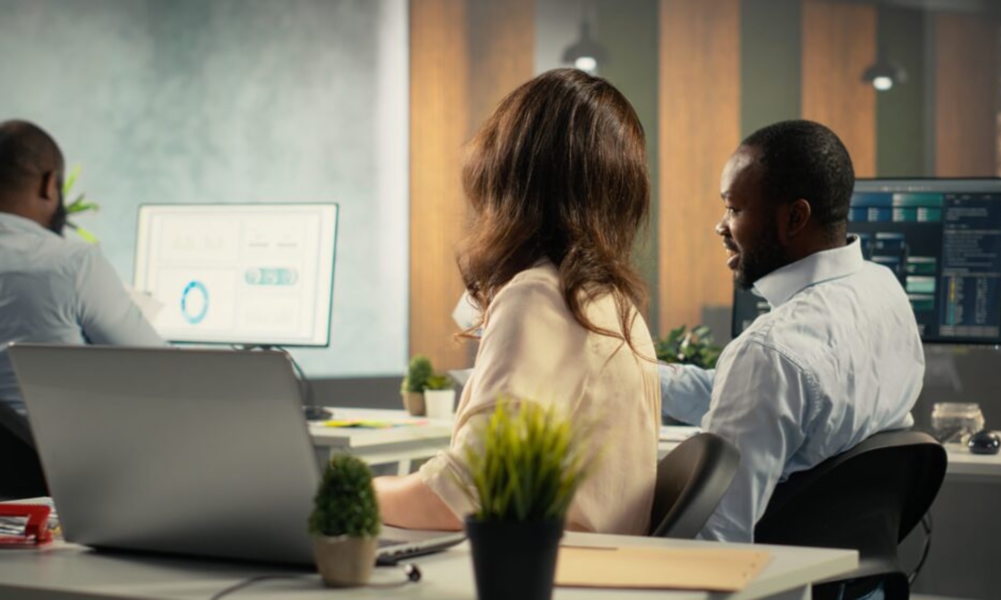 Employees reviewing business intelligence dashboards and analytics data