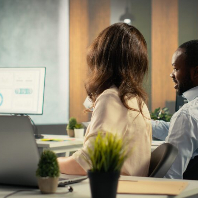 Employees reviewing business intelligence dashboards and analytics data