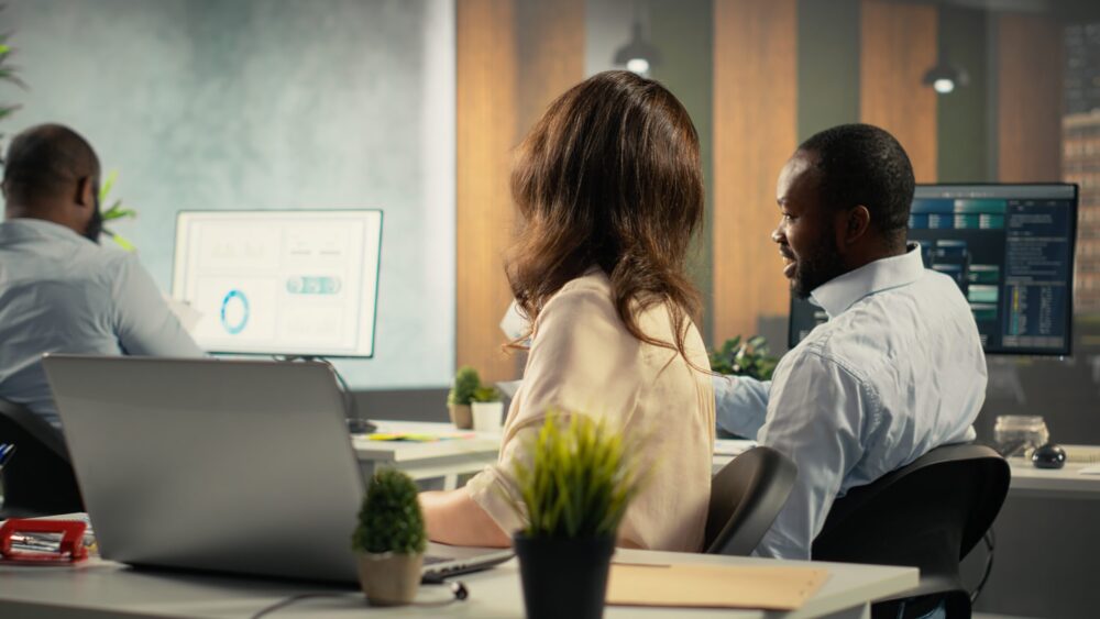 Employees reviewing business intelligence dashboards and analytics data