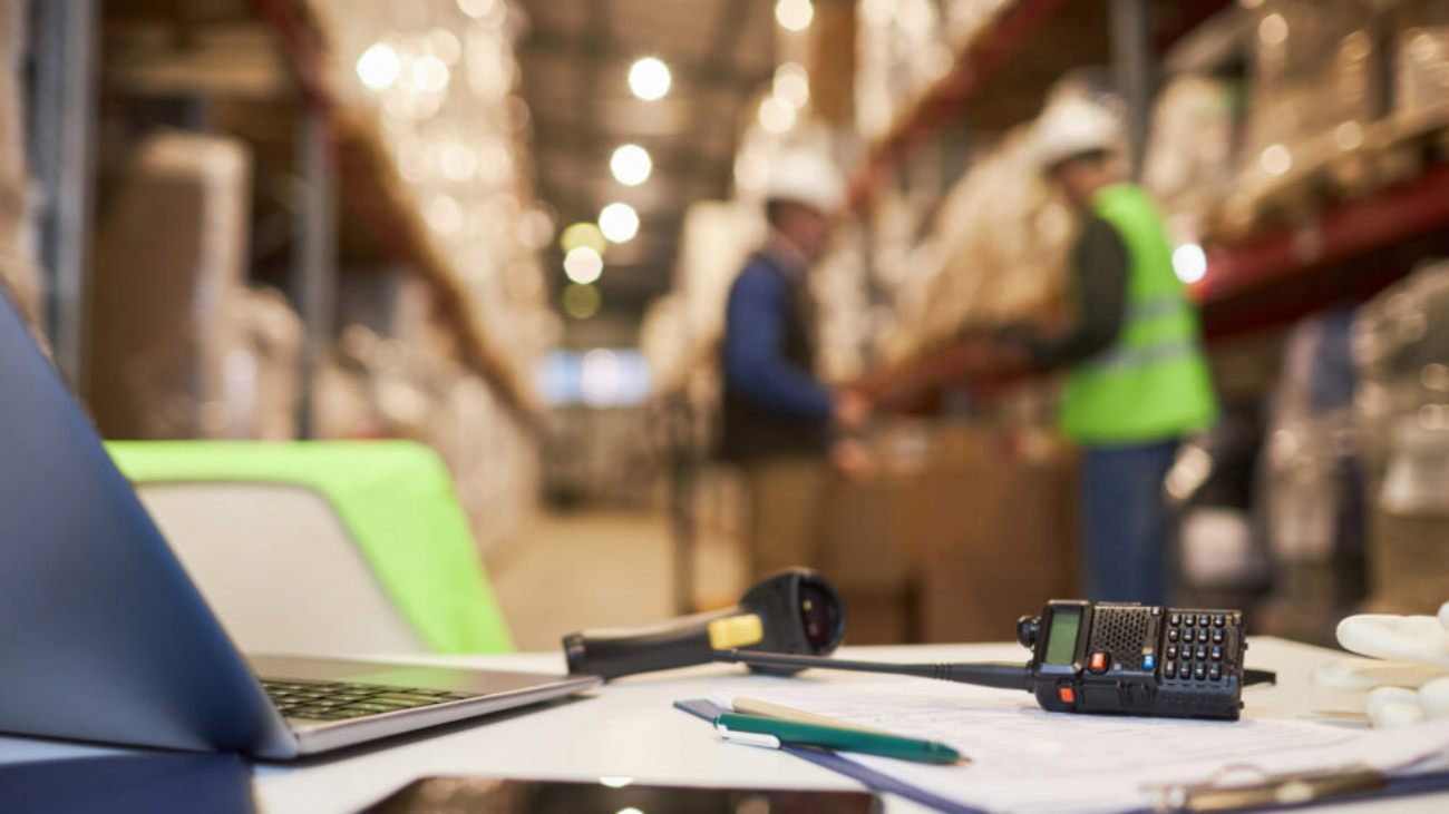 Sage warehouse desk setup with stock control documents and inventory system tools