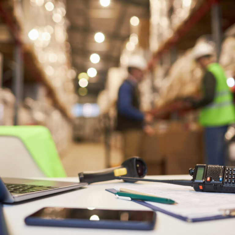 Sage warehouse desk setup with stock control documents and inventory system tools