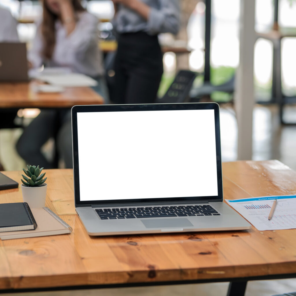 Blank screen laptop on wooden table symbolising Sage Intacct vs Sage 200 ERP software comparison for Irish businesses