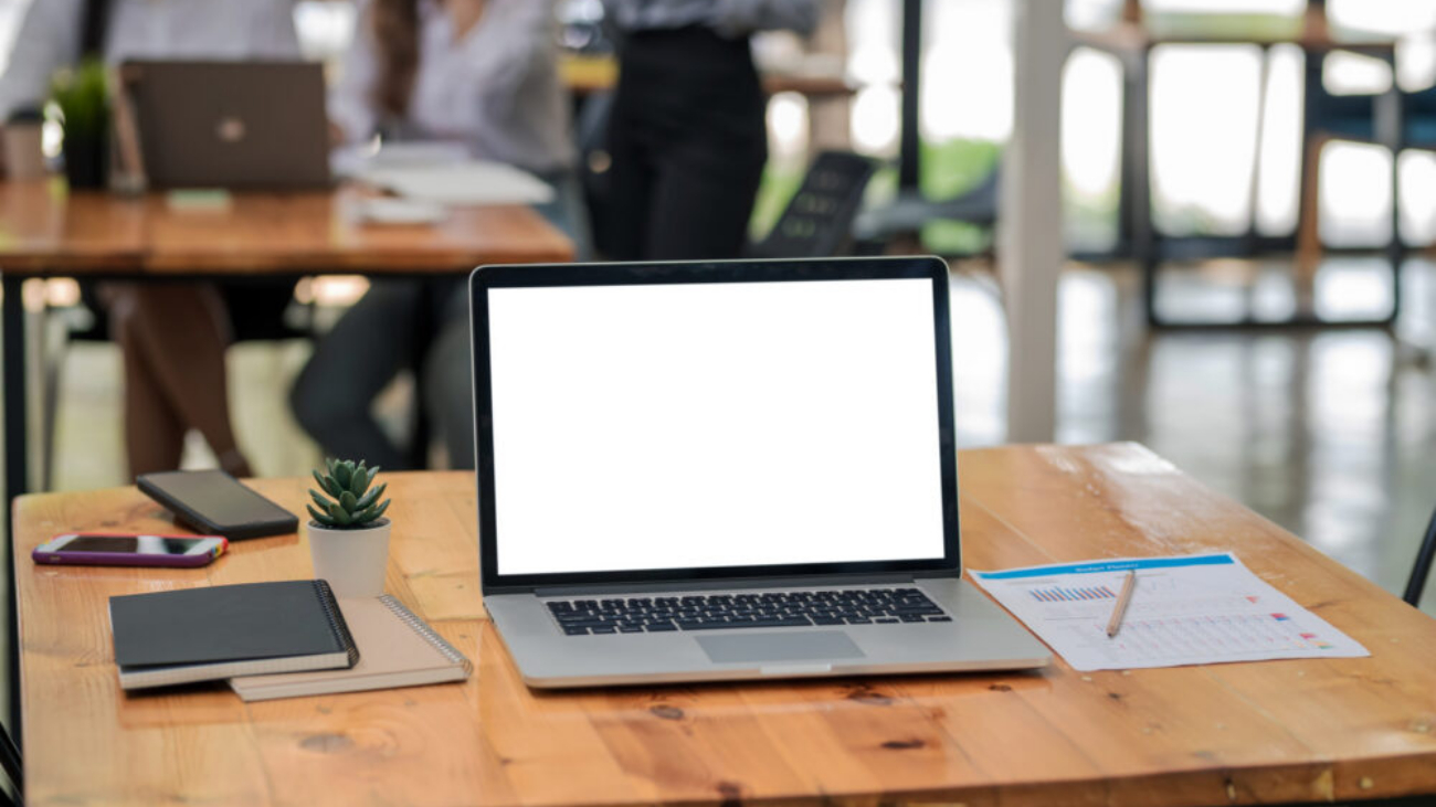 Blank screen laptop on wooden table symbolising Sage Intacct vs Sage 200 ERP software comparison for Irish businesses